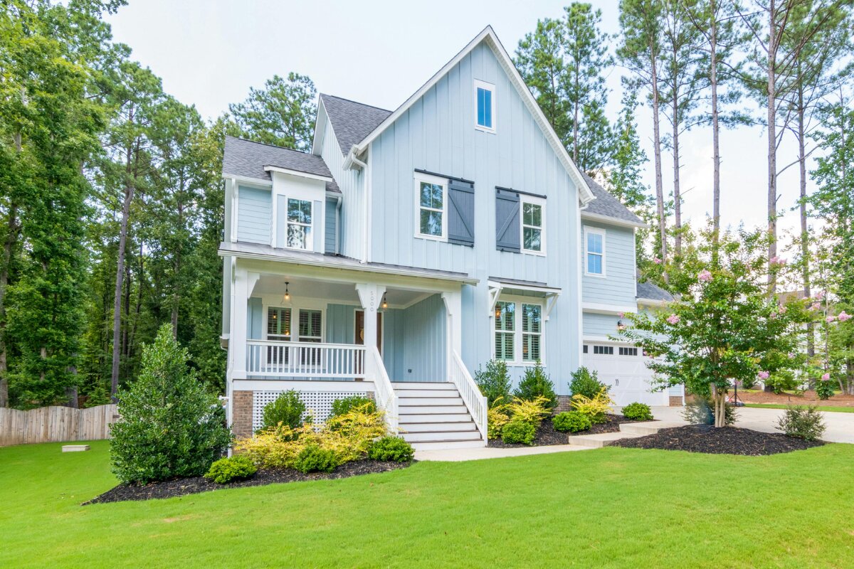 Blue board-and-batten farmhouse install — Foothills Gutter Pro