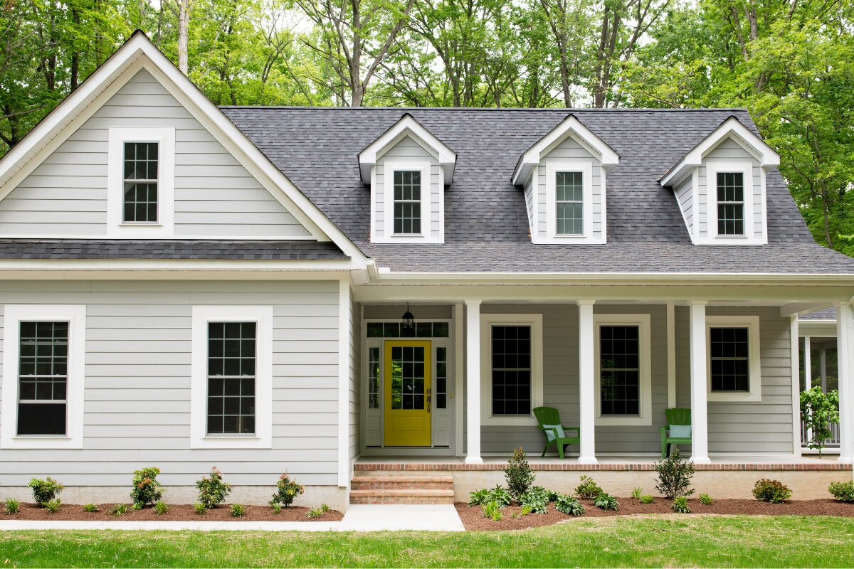 Cape cod home with white gutters — Foothills Gutter Pro